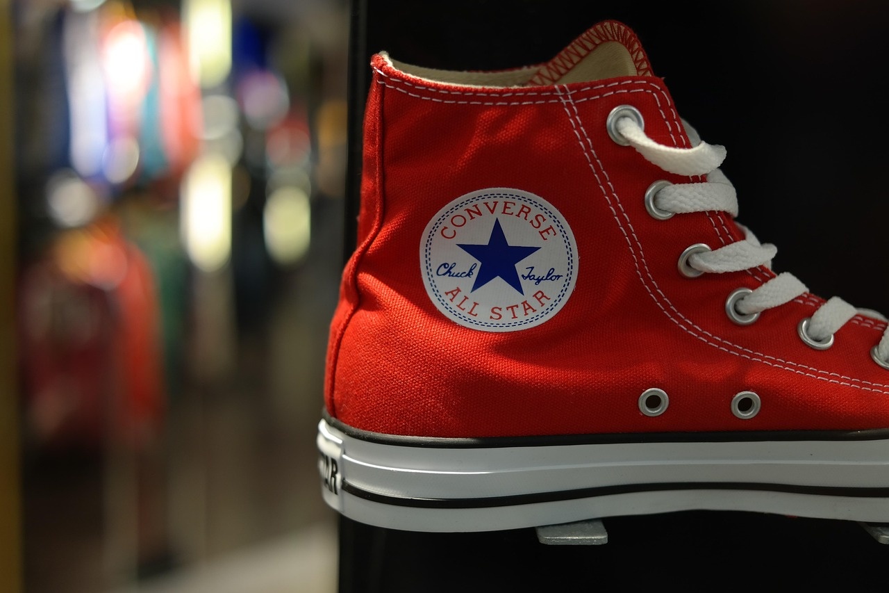 Close-up of a red canvas high-top sneaker showing stitching and rubber sole