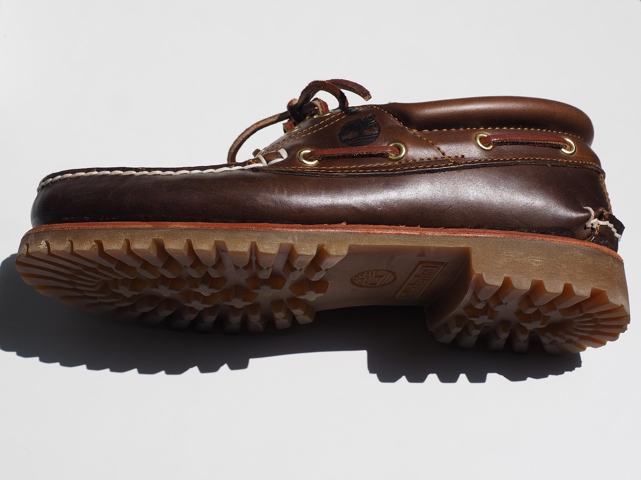 Dark brown leather boat shoe with detailed gum lug sole